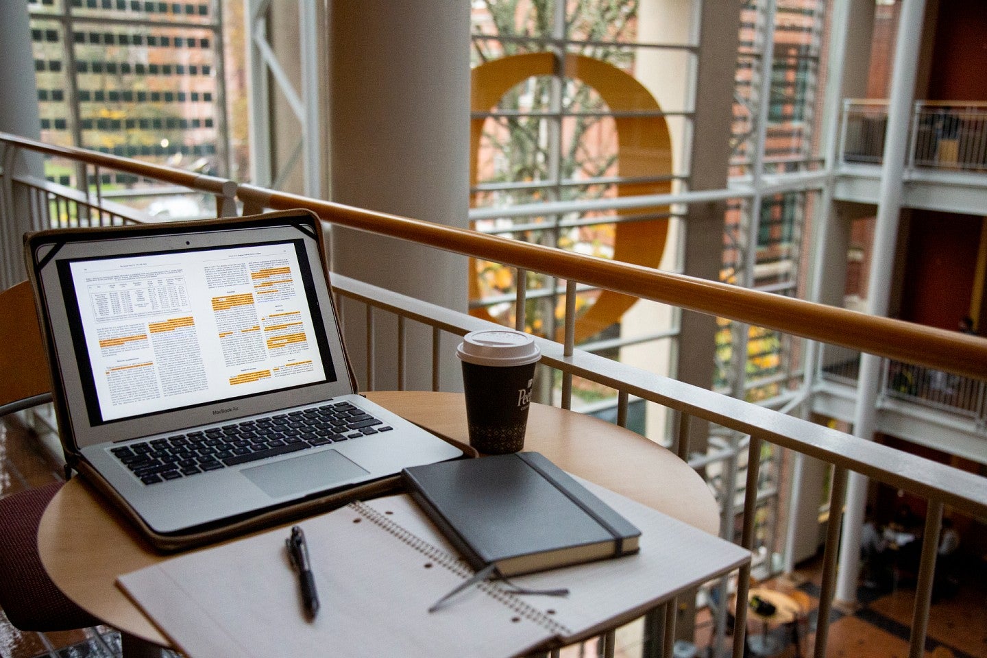 laptop and notes on table inside lillis hall