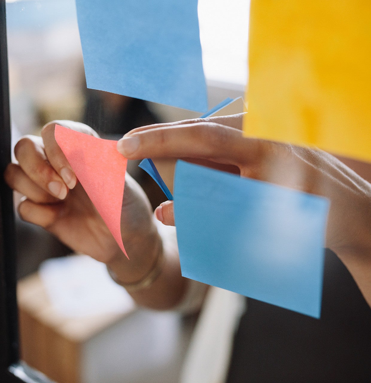 colorful sticky notes on clear board