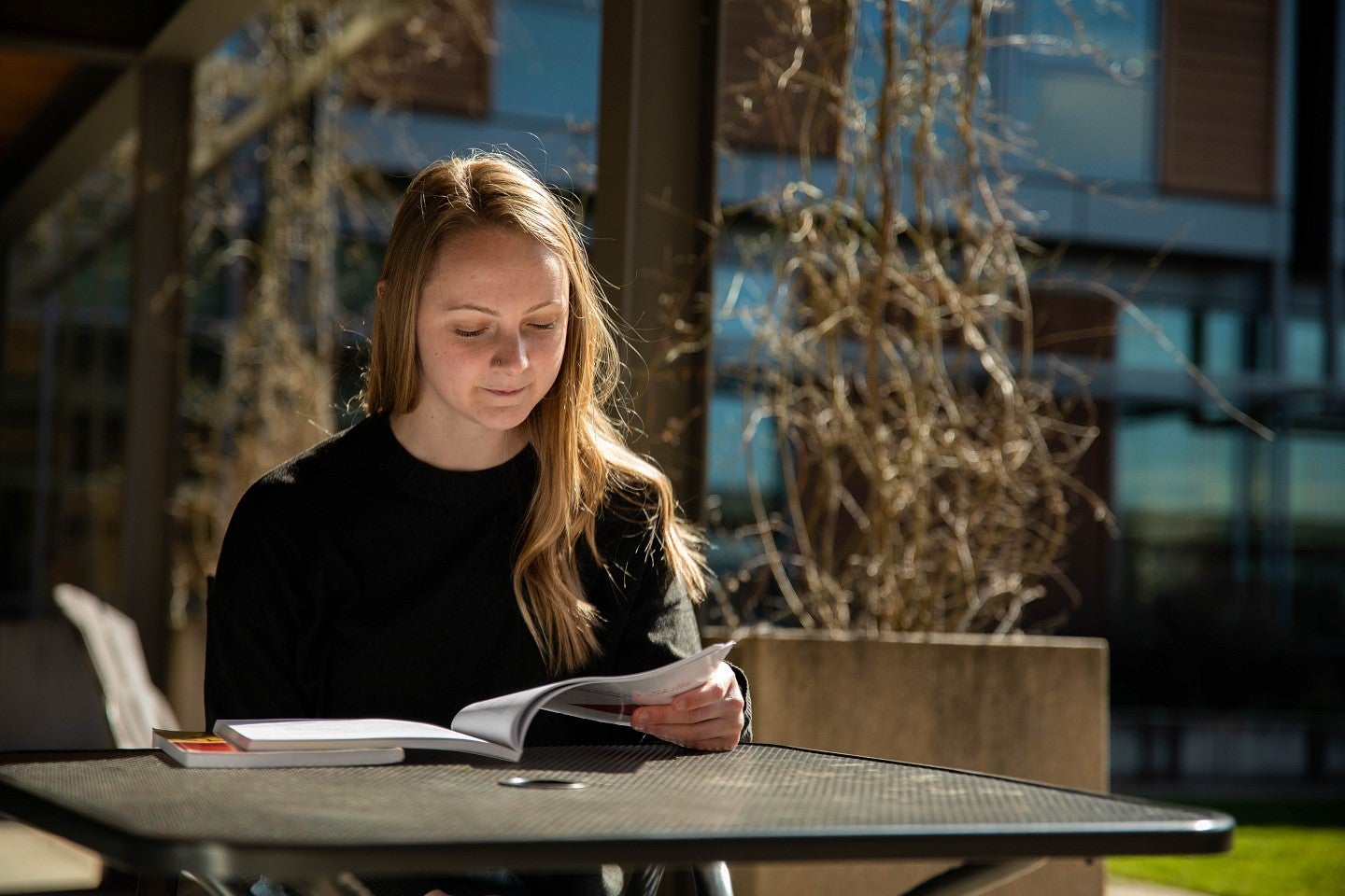 Student reading outdoors