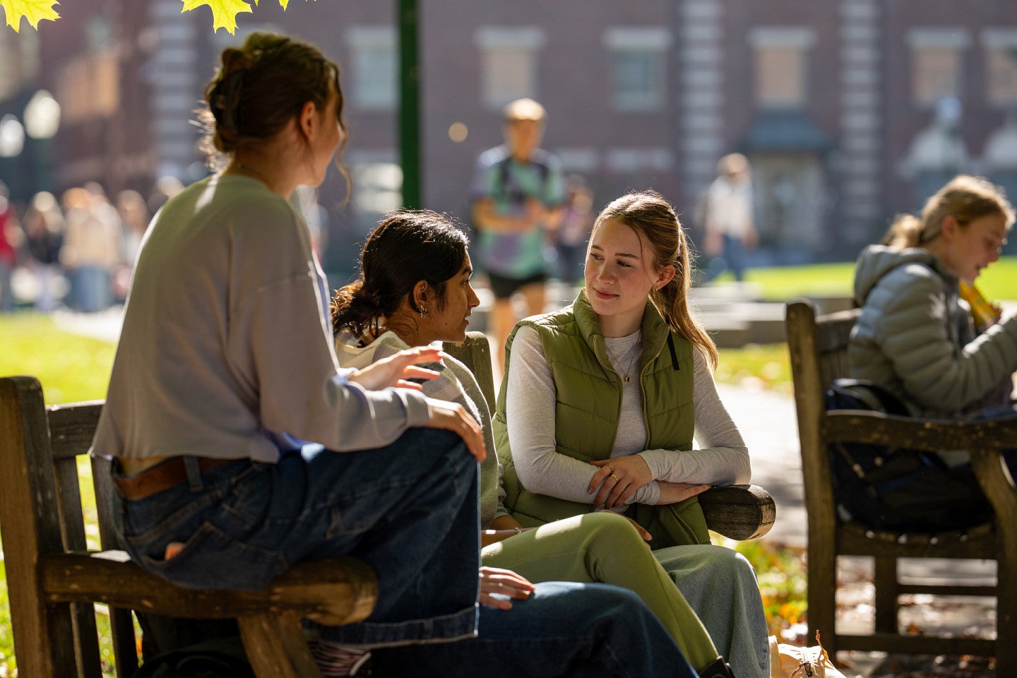 Students sit outside the Eugene campus in the fall