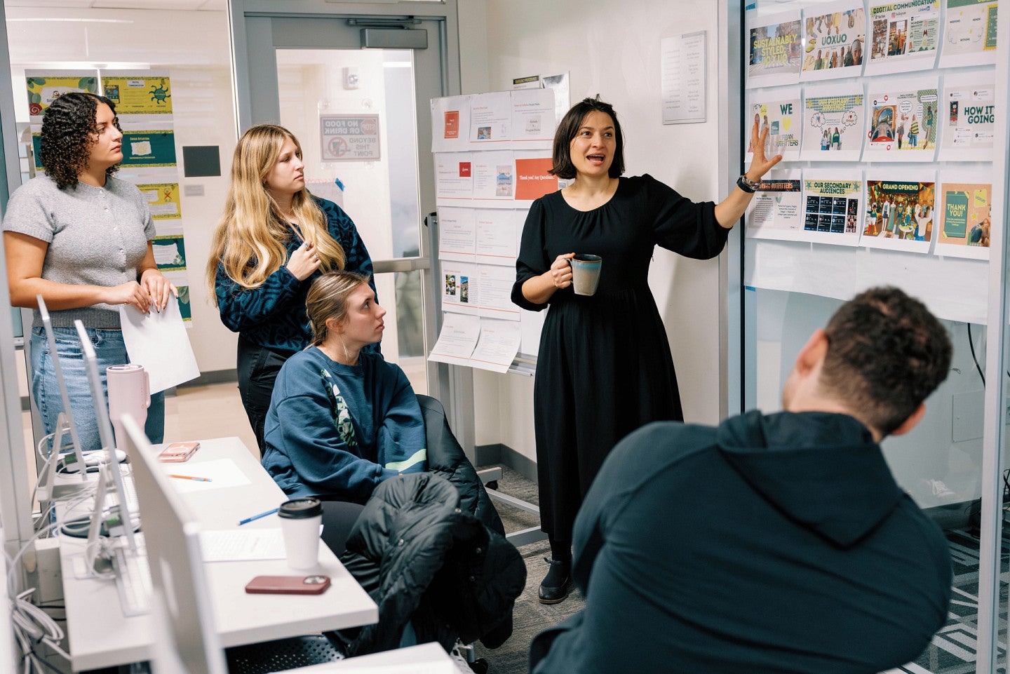 Slavka Eberhart-Garah pointing to board of graphics during class