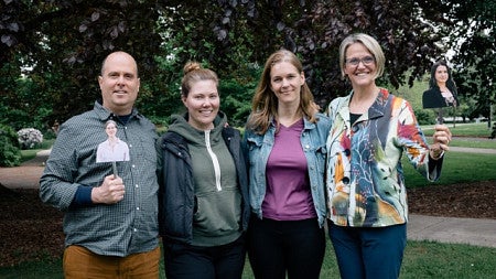 4 participants standing in a row facing forward