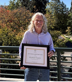 Richard Taylor holds framed certificate