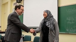 Hanan Elsherif shakes President Schill's hand