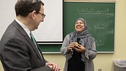 Hanan Elsherif receiving a Distinguished Teaching Award from President Schill